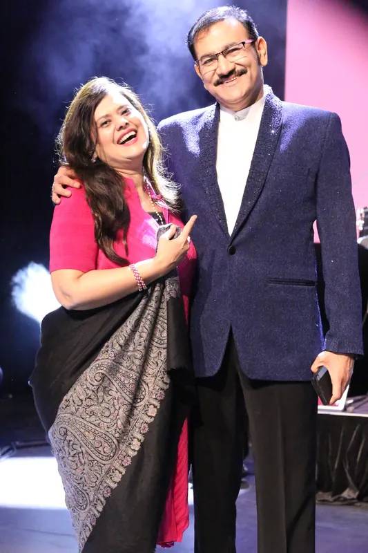 Two performers together on stage after a set