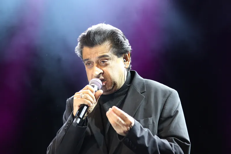 Vocalist performing under low stage light