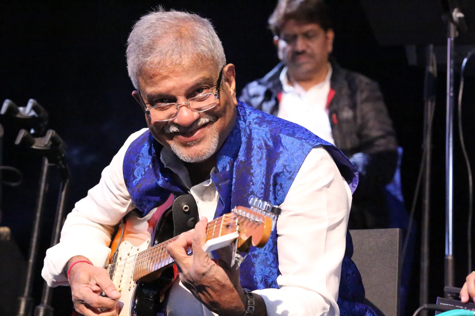 Guitarist smiling during a live set
