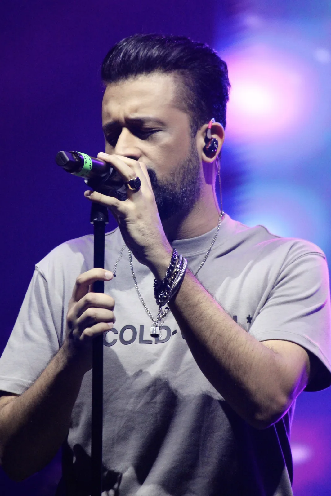 Vocalist performing under blue stage light