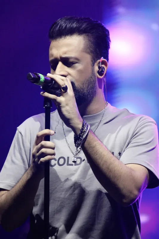 Vocalist performing under blue stage light