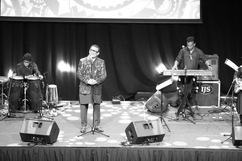 Wide shot of the band on stage, black and white