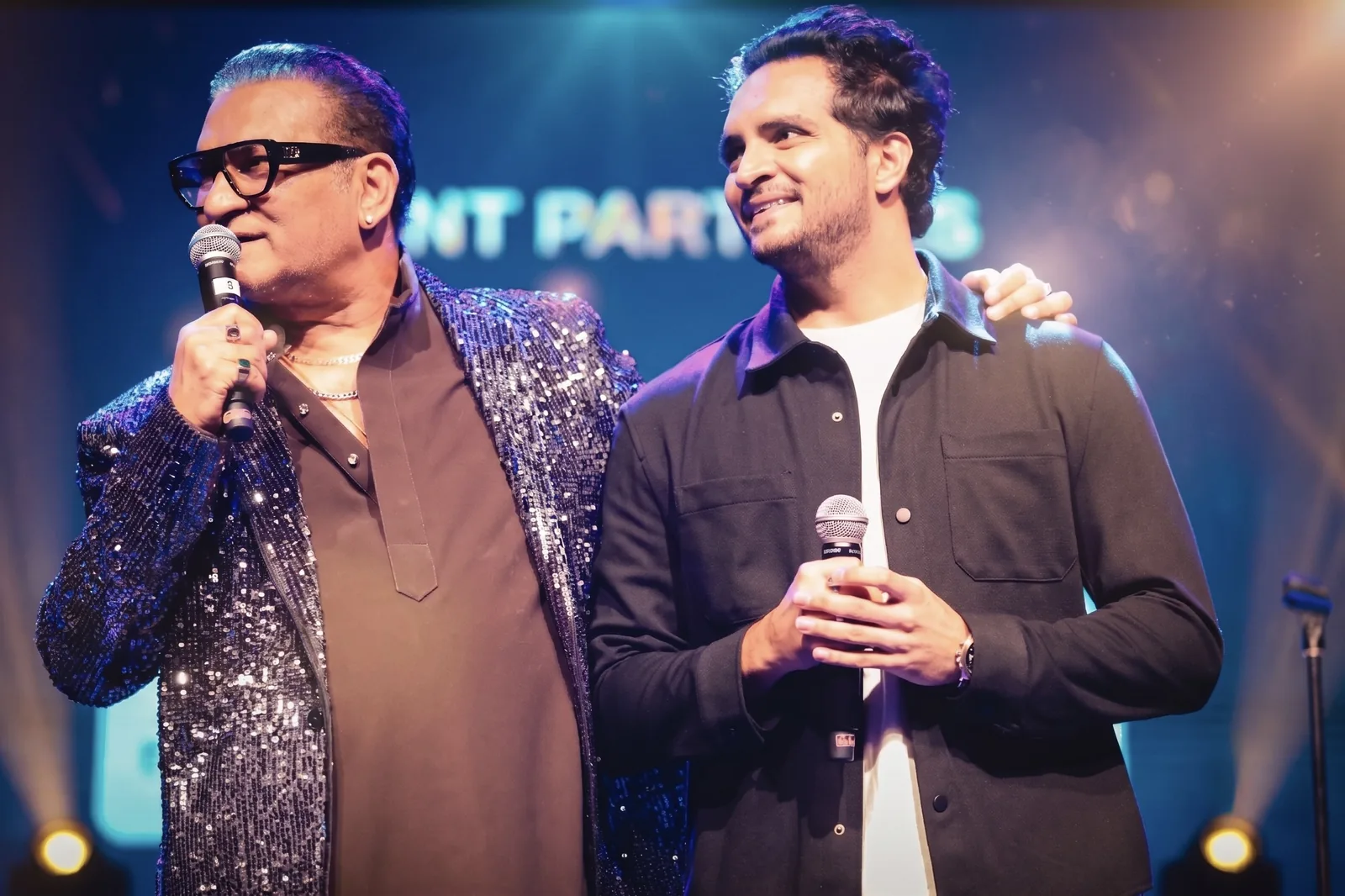 Two performers sharing the stage between songs