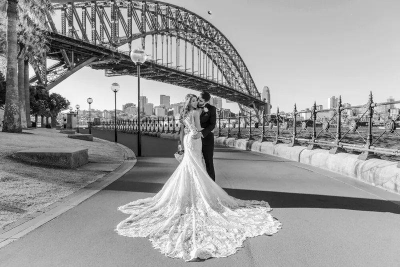 Couple on the harbour foreshore beneath the bridge