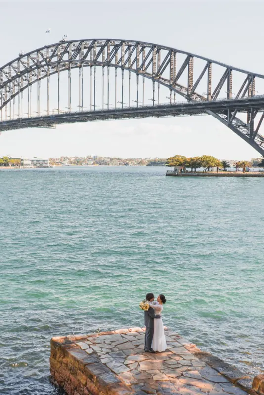 Bride and groom by the water at Sydney Harbour